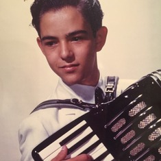 Lou as a young man playing his Accordion! He was a very talented musician! 1956. Lou age 12.