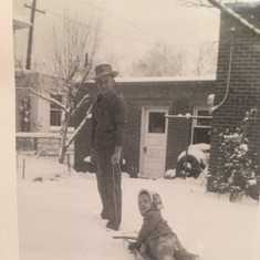 Dad/Lou as a little boy with his Father, Louie Sr. playing in the snow in the backyard of their Denver Home... 1950ish..