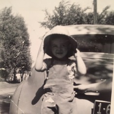 Dad/Lou as a little boy sitting on the car. He always LOVED cars!