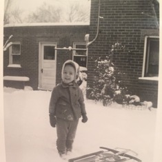 Dad/Lou as a toddler with his Father, Louie, playing in the snow in their backyard.