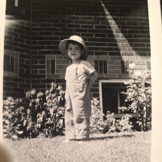 Dad/Lou as a little boy looking super cute playing in their backyard.