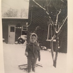 Dad/Lou as a toddler with his Father, Louie, playing in the snow in their backyard.