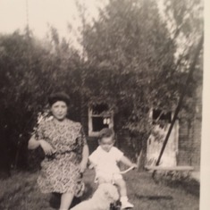 Dad/Lou as a toddler with his Mother, Nettie, swinging in their backyard.