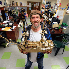 As featured in WordPress.com, Louie Shirpser holds one of several homemade wooden ship models he made and that are on display at the MHA Village in Long Beach.