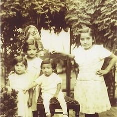 Mom with her brother Alfonso Jr (front) and sisters Daisy and Carmen.