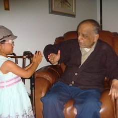 Isabella receiving blessings from Great Grandpa.