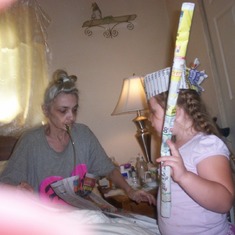 Mom and Micayla Raelynn. Mom had an idea of making dresses, crowns, swords, etc. or whatever you could think of out of newspaper and tape. The kids had a blast... We miss you