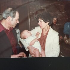 Mom and dad with their first grandchild, Christopher, in 1982.