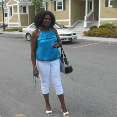 Lucy Asangong outside her home in USA