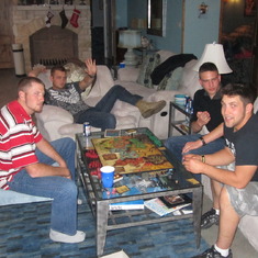 John, Luke, Alex and Jesse playing their battle board game