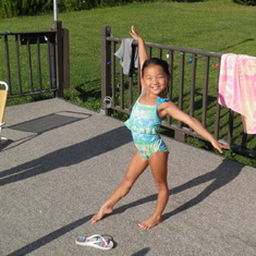 Lydia at the pool doing gymnastics moves