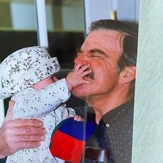 Mimi trying to remove Grandpa's mustache.  Jan, 1996