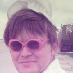Dad goofing around in Chicago, wearing Mary's baby bonnet and sunglasses