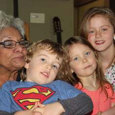 Mum with her great grands - giving squishes