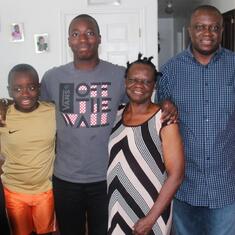 Dr (MRS) OMOTOWA at home in the USA with one of her children, a daughter-in-law and grandchildren