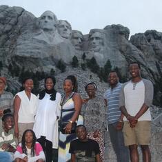 Dr (MRS) OMOTOWA at Mt. Rushmore, South Dakota, USA, with her child, daughters-in-law and grandchildren