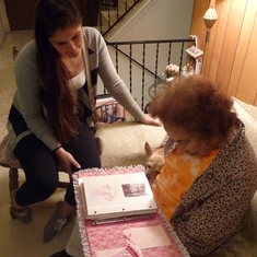 Mika showing Aunt Vicha her Sweet 16 photo album