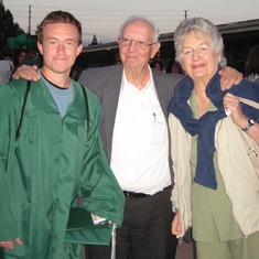 Mom and Dad sharing a photo with Danny after his high school graduation.