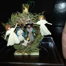 One of Mom's hand created miniature nativity scenes inside a seed pod.  It is about an inch and a half tall.
