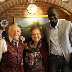Mr. and Mrs. Smith and Nicholas Aru from South Sudan at the Smiths house.