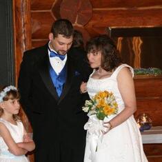 Mark was a groomsman at his mom's wedding.  Next to him is Tia, his oldest neice, and his son Mark. May 2008.