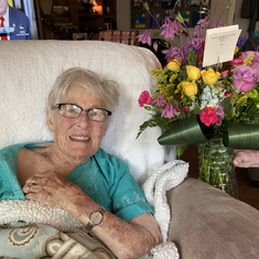 One of the last photographs of Marolyn — delighted at having received flowers from grandson Will.