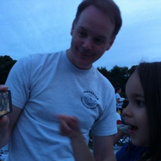 Martin showing Nadia a game on his iPhone, while waiting for 4th of July fireworks