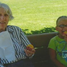Gma & Addie having fruit in the park 08-13-11