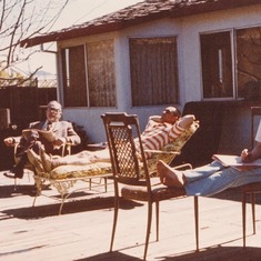 Mom, Dad, and Grandpa relaxing on the new deck and reading to her heart's delight.