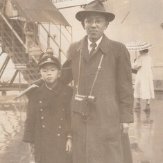 Mas and his father Jiro in front of the ship to America