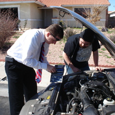 Mat showing Keats how to fix his car.