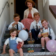 Mom on stairs with young boys and Easter baskets