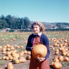Mom standing with pumpkin