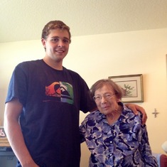 Sam showing Grandma how tall he got since the last time he visited.