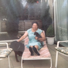 Mum at home in the garden with the pets Twiggy and Cindy.