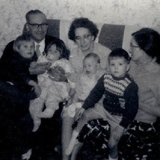 Mavis to the right> and young son Richard sat on lap.