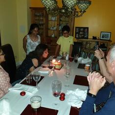 Meet blowing out candles of her 56th birthday cake at the Brennan household