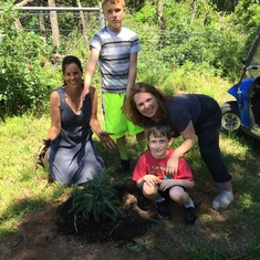 Mary, April, Tristan, and Jack planting some Colorado Blue Spruce in memory of Mike on 6/6/16.