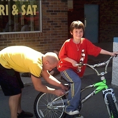 Michael helping my son get his new bike all fixed up and ready to go.