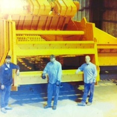 Tim Saddler , John Poe and Mike Cardwell...standing in front of one of the machine he worked on...