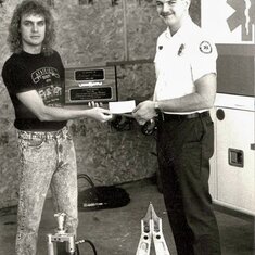 Michael receiving check for Jaws of Life from Mark Martin