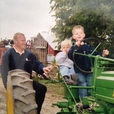 One of my favorite pictures.  The tradition of learning to drive tractor on the John Deere B.   