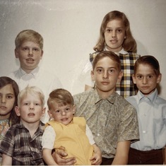 Michael the oldest of seven children shown in age order Nancy, Susie, Allen, Paul, David, and Karl