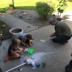 Taken moments after arriving at his Uncle Pete’s in MT.  Chalk art with cousins Jo and Selah.  