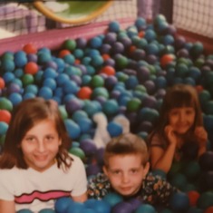 Ball pit with his sisters