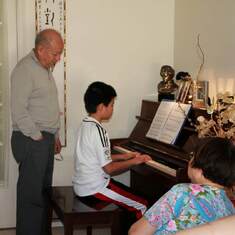 Uncle Michael watching Ryan play the piano at the Tang's home in Vancouver (14 July 2010)