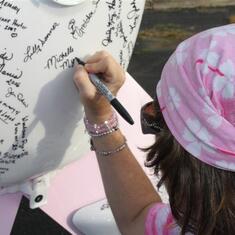 Michelle Signing the Motorcycle at Race 4 Hope 2010.