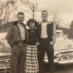 With his brother and sister with their cars