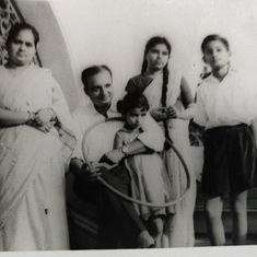 With her parents, aunt and elder brother