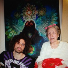 Myriam with her grandson Chad Haarman who painted the painting pictured behind them.